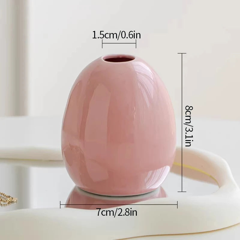 A pink ceramic mini vase is shown on a white surface with dimensions marked.