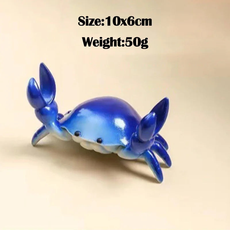 A small, bright blue crab-shaped desk organizer with slots for a pen and phone.