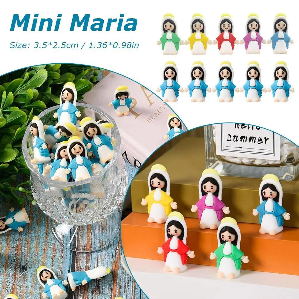 A collection of Mini Maria religious desktop figurines and ornaments in various colors displayed on a clear glass stand.