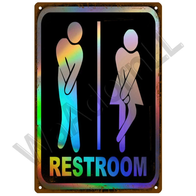 A vintage metal sign with silhouettes of a male and female figure indicating a restroom.