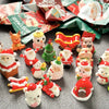 A collection of festive Santa Claus and snowman figurines for Christmas decor arranged on a dark surface.