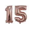 Two rose gold foil number balloons shaped like 15 for birthday party decor