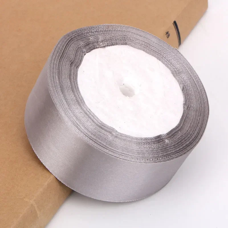 Roll of silver satin ribbon for crafts and gift wrapping