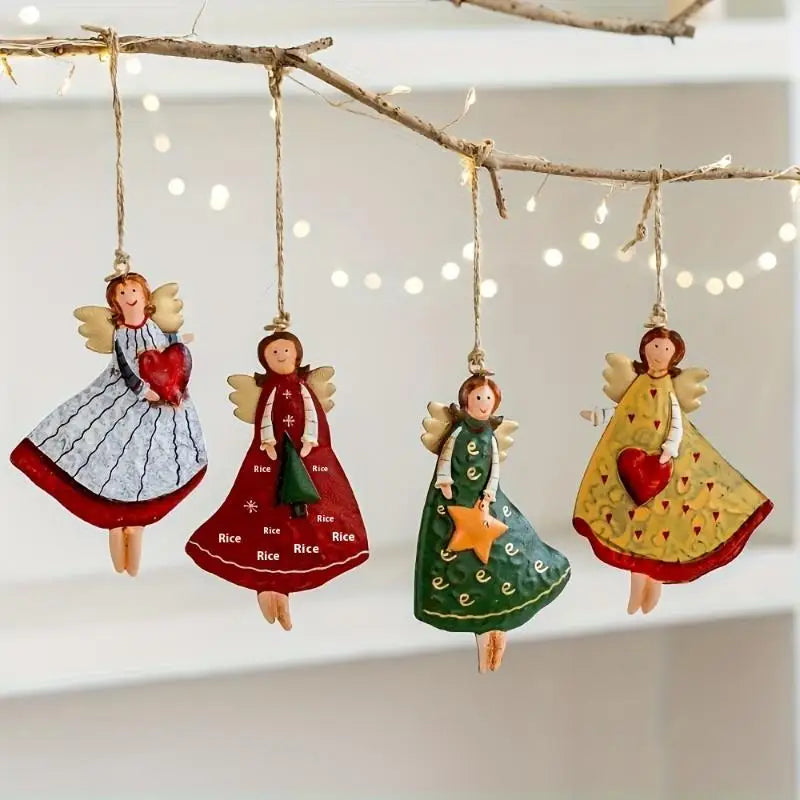 A set of four vintage wood angel ornaments with red and green accents hanging from a bare branch.