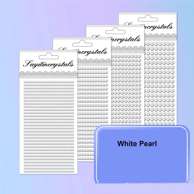 A collection of white pearl self-adhesive rhinestone embellishments in various sizes and patterns.