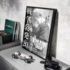 A framed poster of Vinland Saga anime featuring a character, displayed on a light gray shelf.
