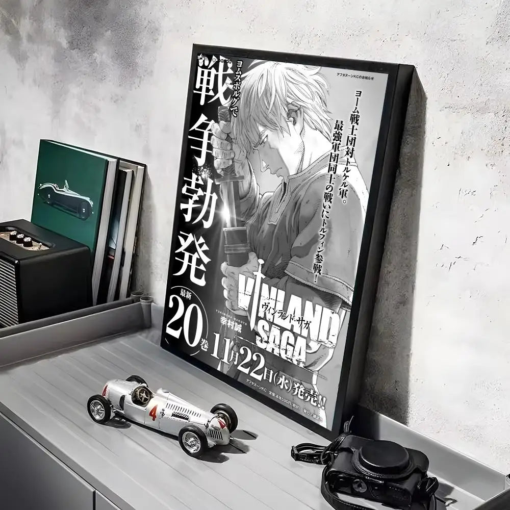 A framed poster of Vinland Saga anime featuring a character, displayed on a light gray shelf.