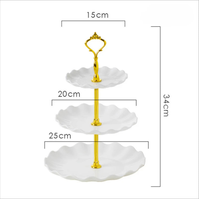 A three-tier gold plastic dessert stand with white scalloped plates.