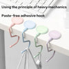 Paste-free adhesive hook in various pastel colors attached to a white surface.