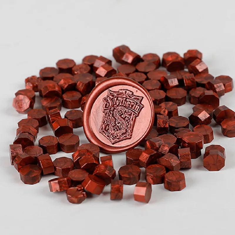 A pile of reddish-brown wax sealing beads used for custom stamps.