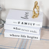 A set of three modern decorative fake books in white featuring gold accents and text about love, family, and life.