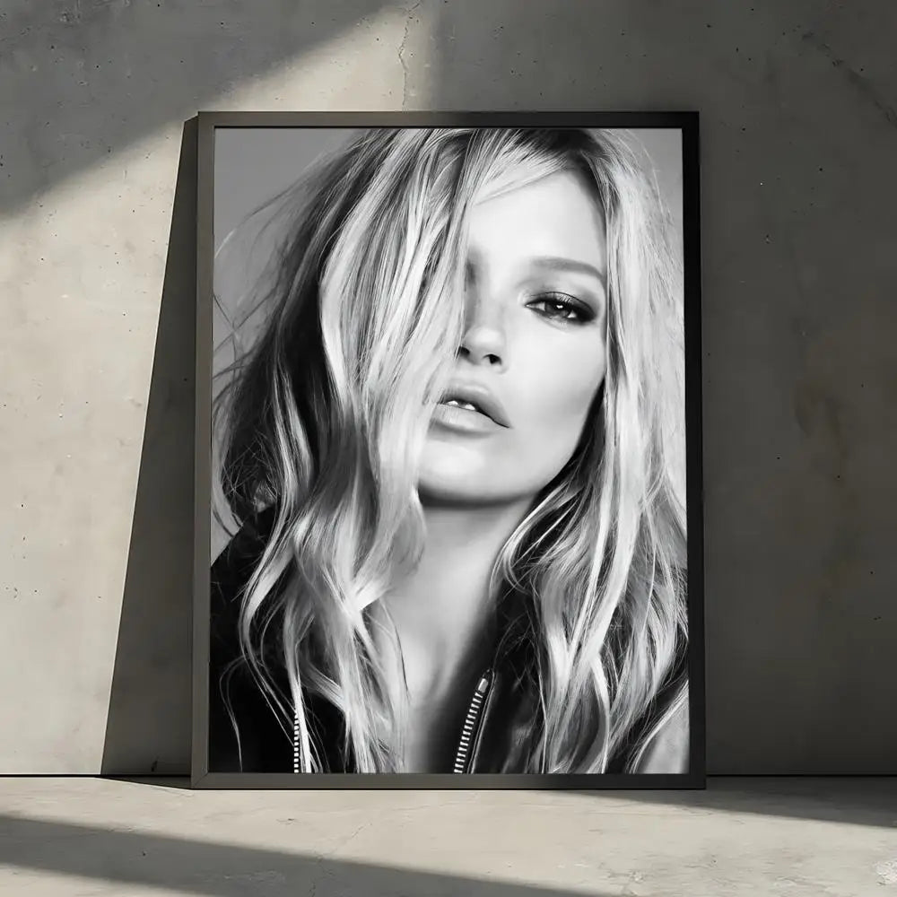 Black and white portrait of a blonde woman with wavy hair looking directly at the camera in a framed print.