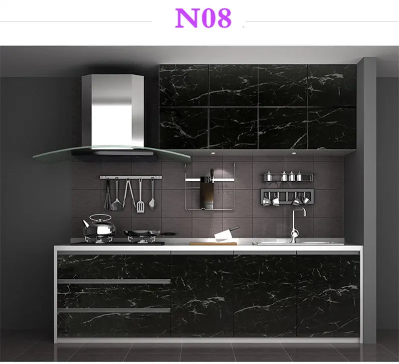 A modern kitchen cabinet featuring black marble contact paper for countertops and cabinetry.