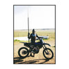 A person wearing a helmet and riding a dirt bike is shown in an outdoor, dusty environment.