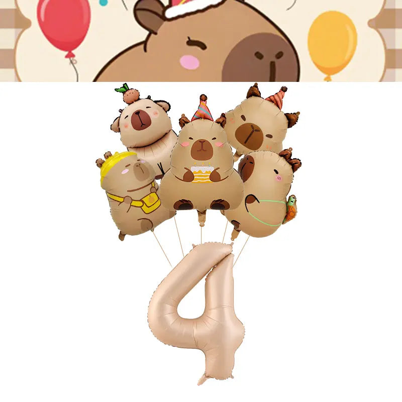 A set of cute capybara-themed birthday decorations including plush toys and a large number balloon.