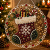 A clear acrylic round ornament featuring a detailed Christmas stocking design with red and green glitter and pearl accents.