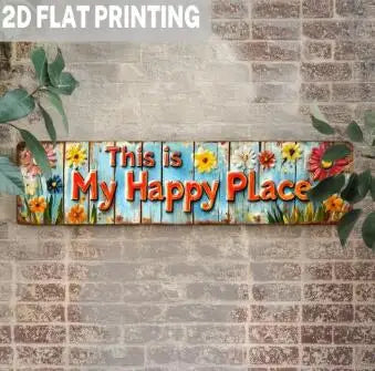 A wooden sign with the text This is My Happy Place painted on it, featuring colorful flowers and greenery.