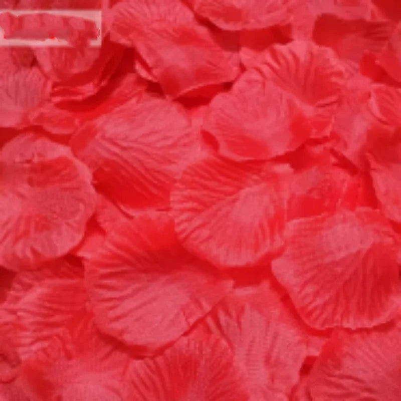 A close-up of vibrant red silk rose petals used for weddings and events.