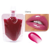 A bottle of cherry flavored lip oil gloss next to a close-up of the glossy pink product and lips