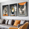 A set of three modern geometric canvas wall art pieces featuring abstract shapes in gold, gray, and orange tones.