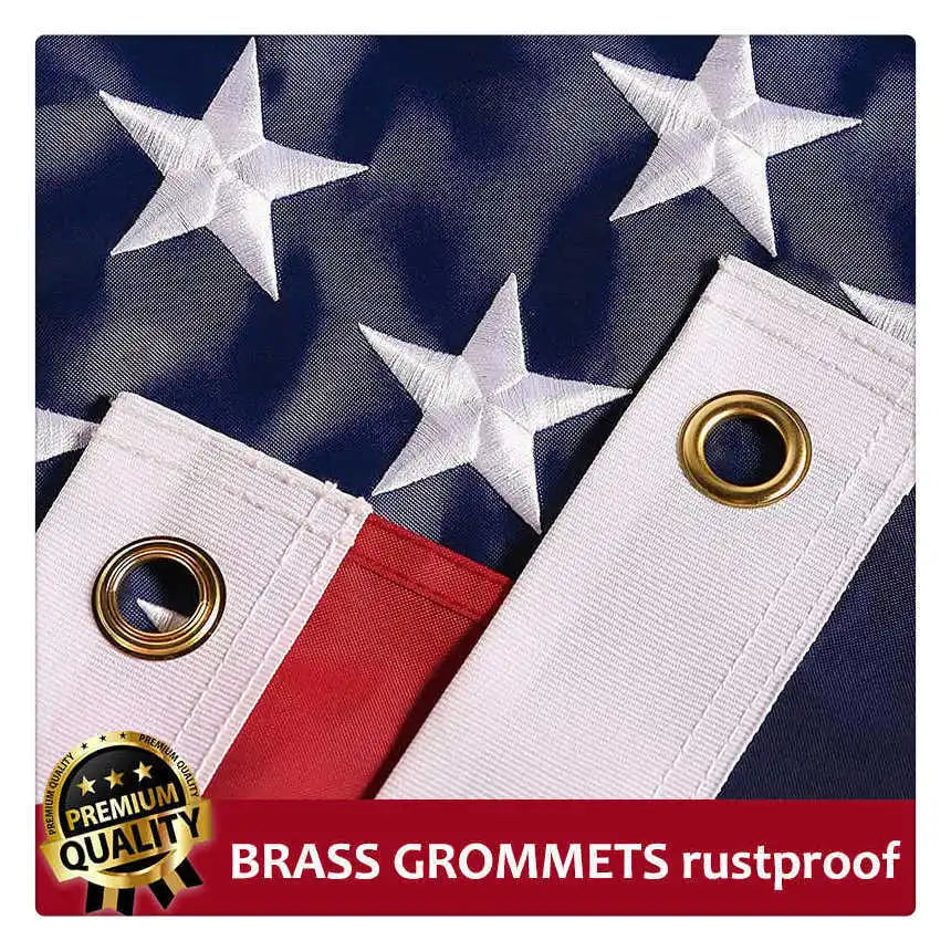 Close-up of a white embroidered American flag with brass grommets on a dark blue background.