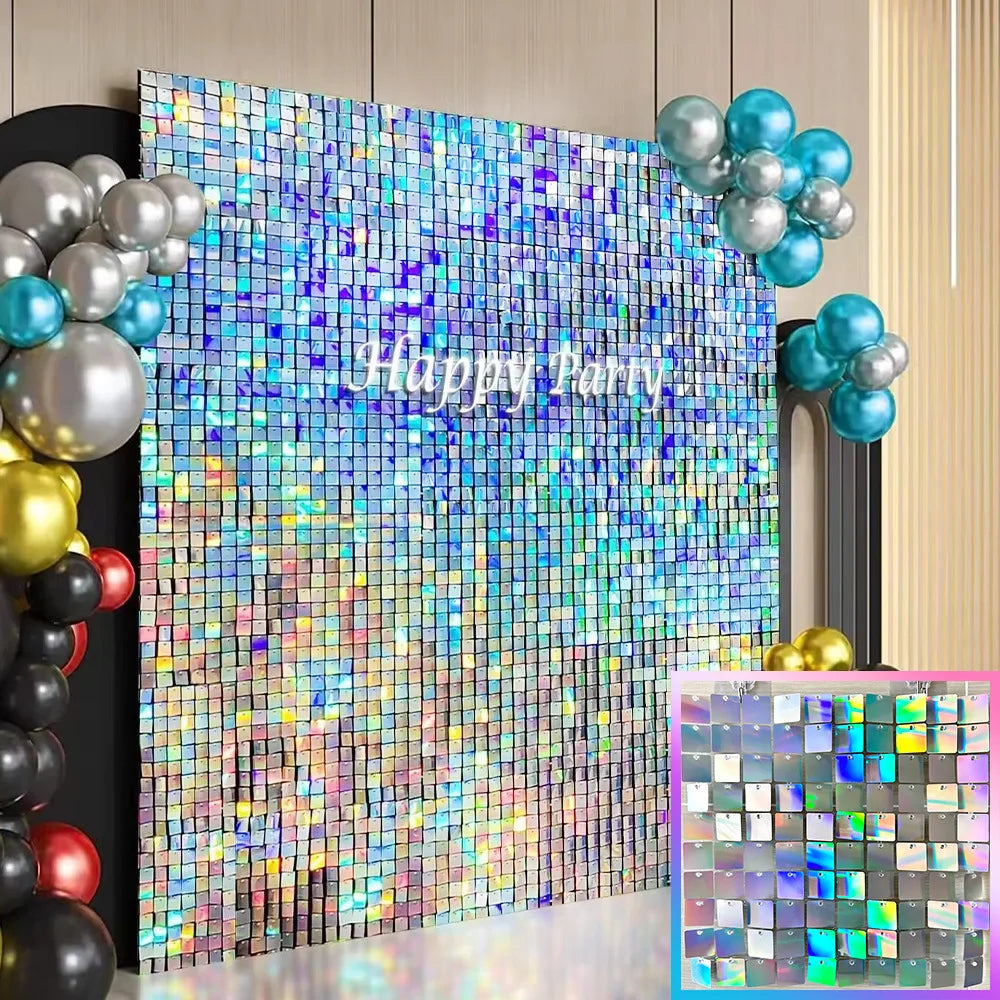 A sparkling square glitter wall backdrop featuring iridescent colors and blue and silver balloons.