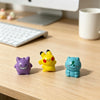 A set of six colorful kawaii anime fantasy creature mini figurines displayed on a wooden desk.