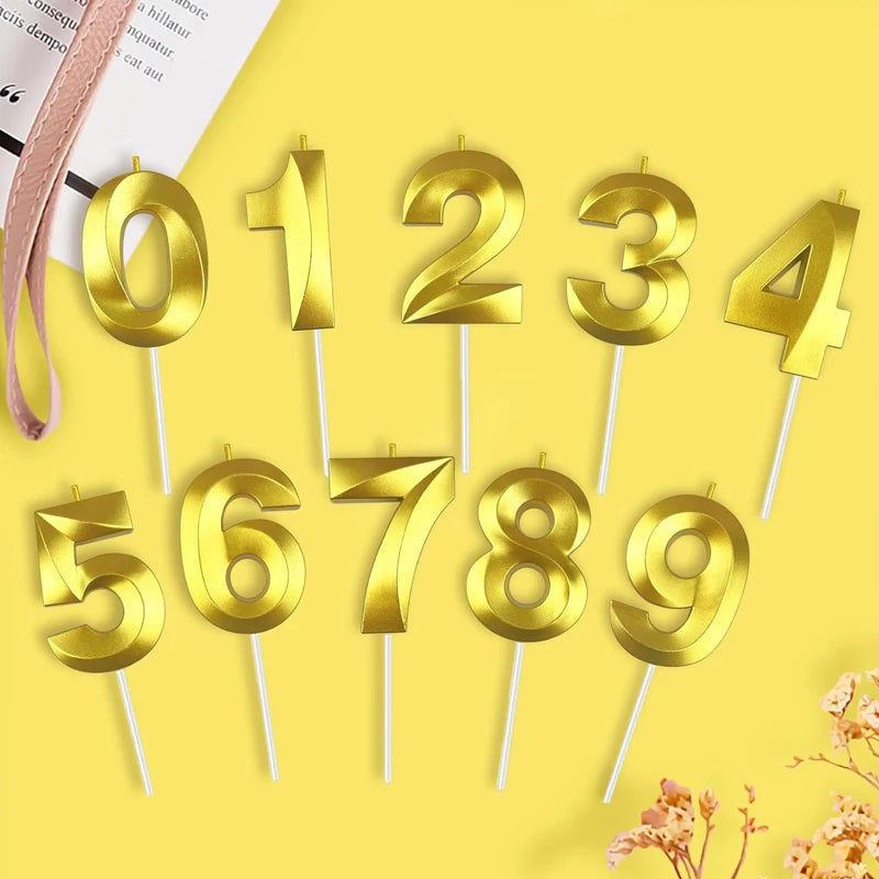 A collection of gold numbered candles, 0 through 9, on white sticks, against a yellow background.