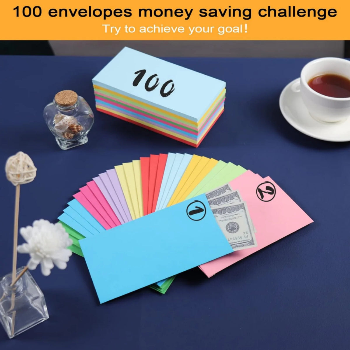 A flat lay of colorful side-loading cash envelopes, stacks of paper, and a cup on a dark blue surface for a money saving chal