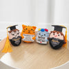 A collection of handmade crochet potato dolls with inspirational slogans and graduation themes.