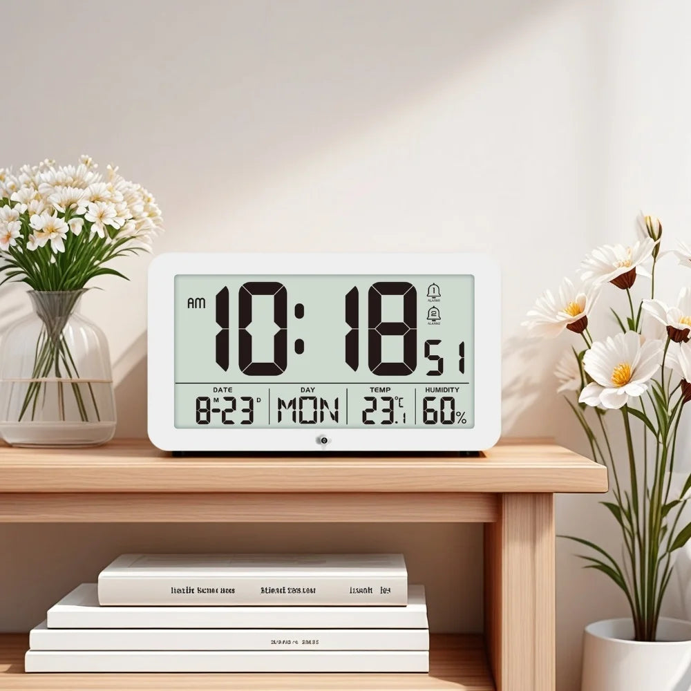 A white digital wall clock displaying 10:18 AM with temperature, humidity, and alarm settings on a wooden shelf.
