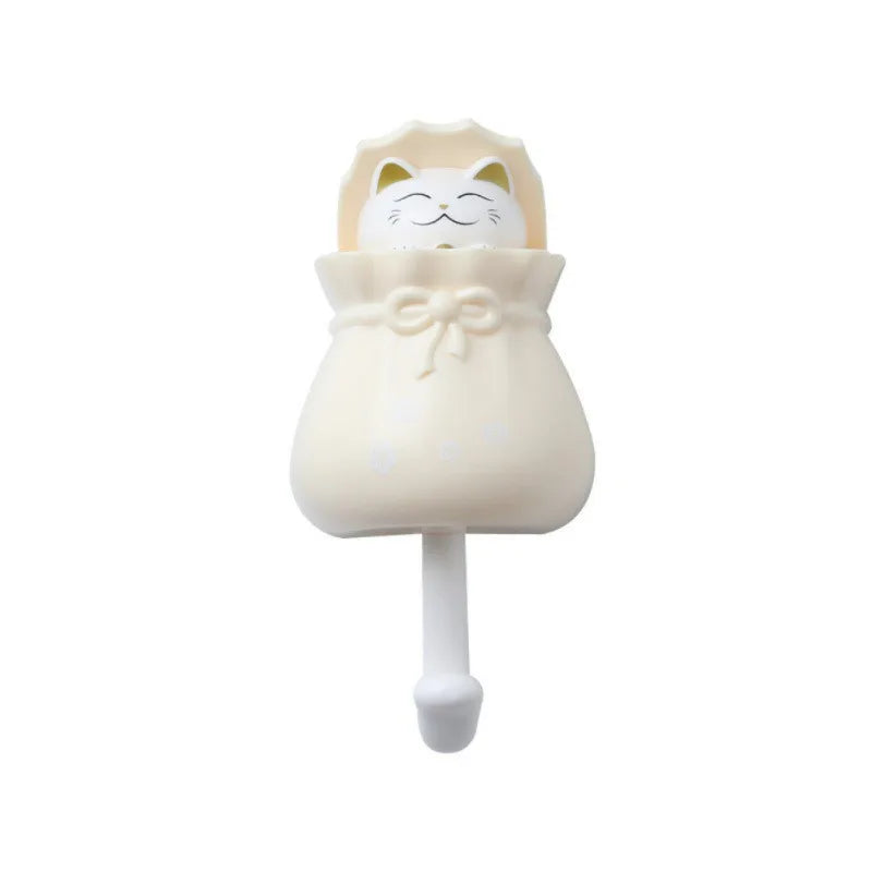 A white cartoon cat wall hook with a bow detail.