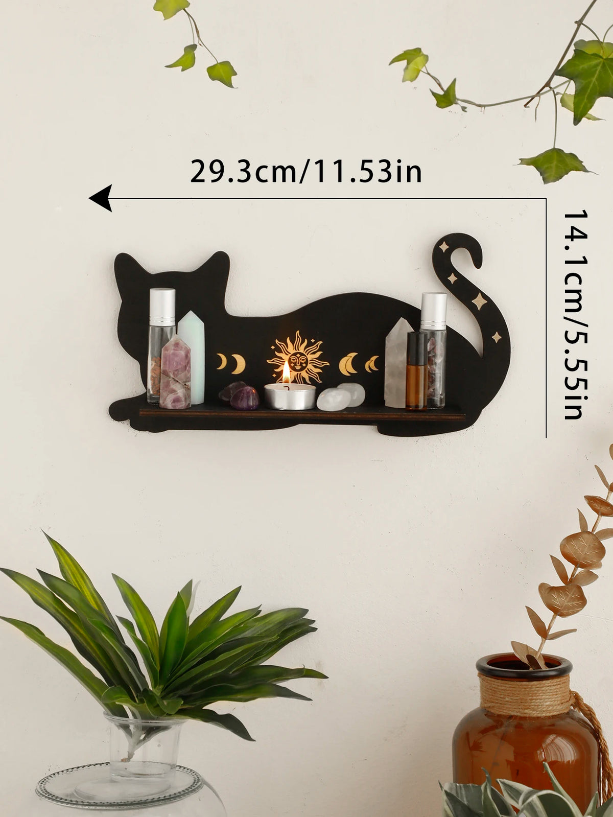 A black cat wall shelf displaying various candles and crystals, featuring a moon phase design.