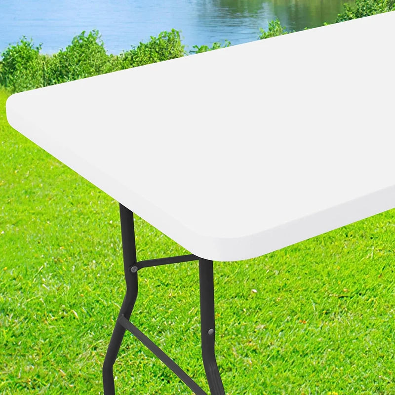 A white stretch tablecloth is displayed on a black metal stand in a grassy outdoor setting.