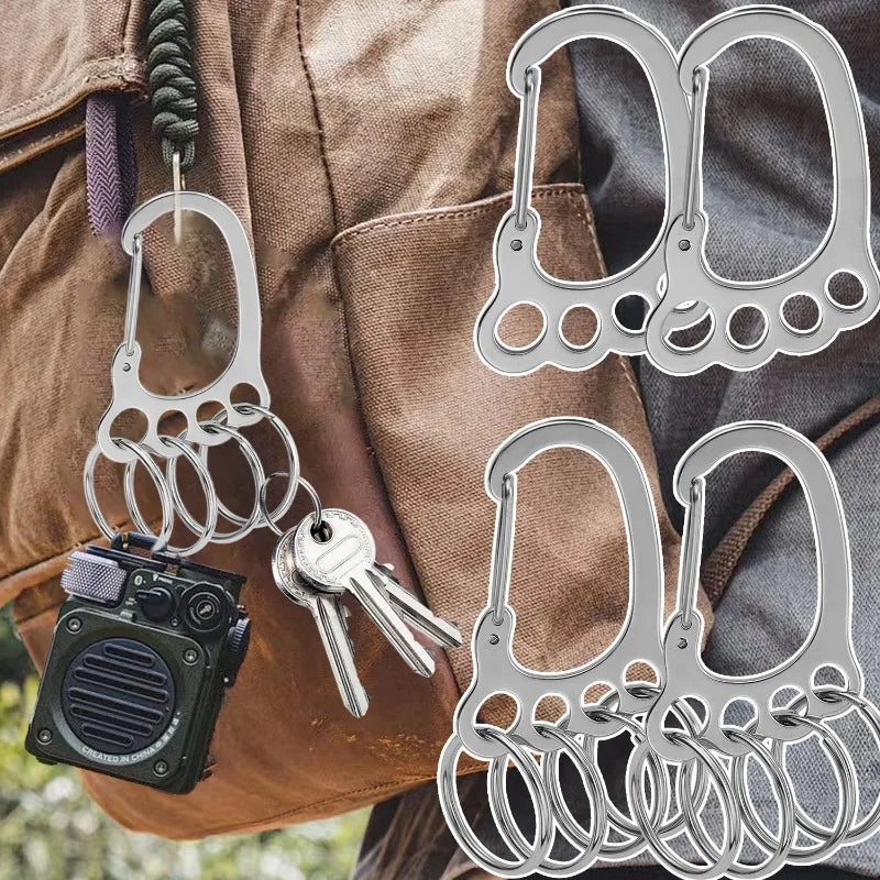 A collection of durable stainless steel keychains with multi-loop designs are displayed against a brown canvas bag.