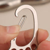 A hand holds a durable stainless steel keychain with a multi-loop design, showing the curved metal rings and small holes.