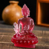 A handcrafted resin statue of Medicine Buddha in pink, seated on a red base.