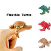A hand holds a flexible turtle figurine, showing its texture and articulation.