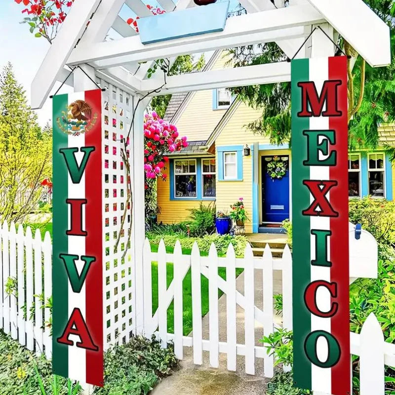 A white picket fence banner featuring the words VIVA MEXICO in red, green, and white on a porch display.