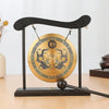 A black Feng Shui Zen table gong featuring a brass plate with dragon and Taiji symbols.