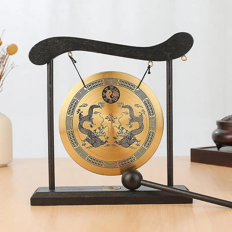A black Feng Shui Zen table gong featuring a brass plate with dragon and Taiji symbols.