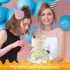 A woman displays a portable cake display box with a decorated cake and flowers against a pink background.