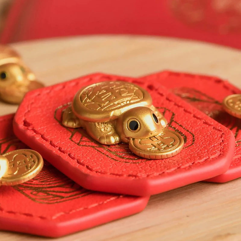 A golden tortoise figurine for wealth luck home decor resting on a wooden surface.