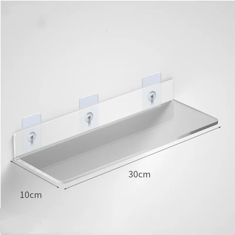 Clear acrylic floating shelf with wall mounts, measuring 30cm long and 10cm deep.