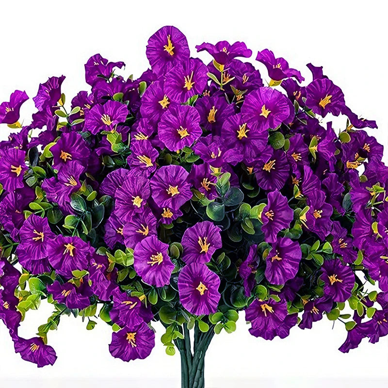 A bouquet of artificial purple morning glory flowers and green eucalyptus stems.