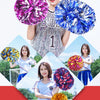 A young woman holds several vibrant pom poms in various colors including purple, blue, and gold.