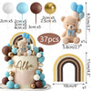 A teddy bear cake topper featuring blue and white foam balls and a rainbow arch.