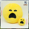 A yellow plush doll shaped like an angry face, used as a stress relief pillow.