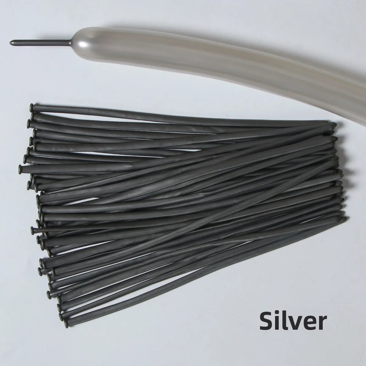 A bundle of silver latex strip balloons and a smooth, light-colored tube are shown.