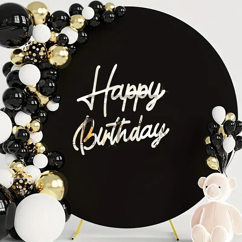 Black backdrop decorated with gold and black balloons and silver script reading Happy Birthday and a pink bear figure